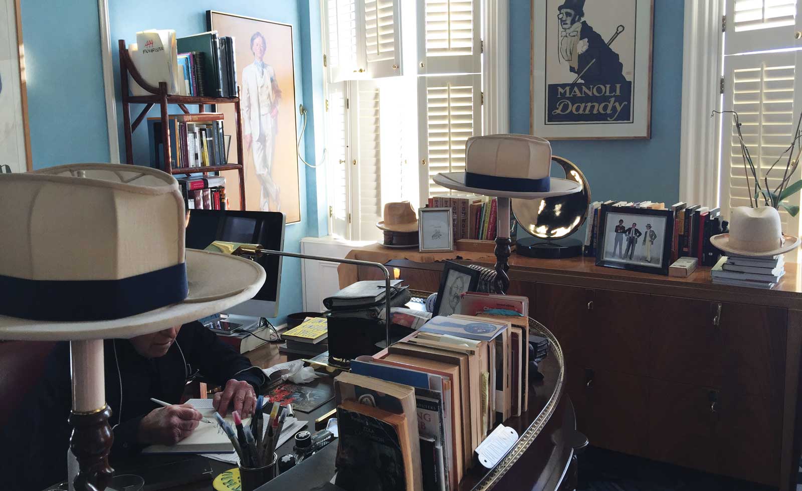Inside Wolfe's home office. Note the fedora lampshades.
