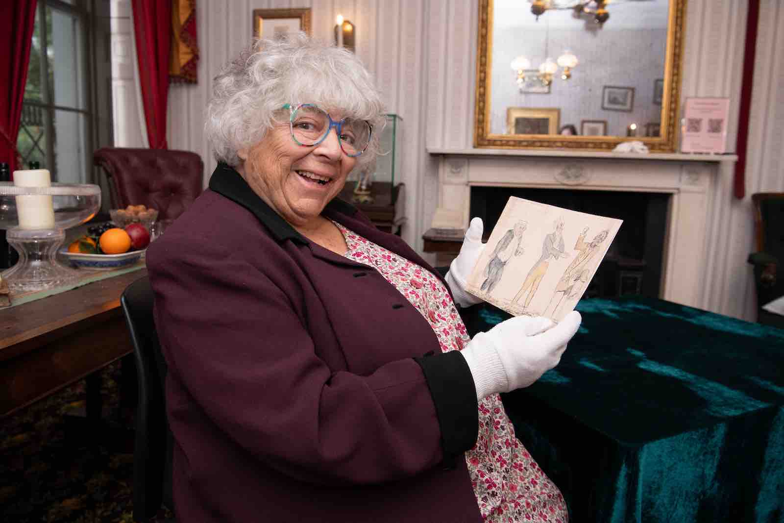 Charles Dickens Museum Patron Miriam Margolyes examines a sketch of Dickens performing.